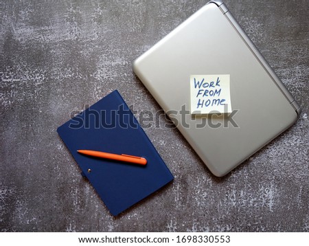 layout of a laptop, pen, notebook on the surface for remote work