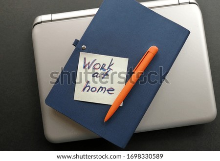 layout of a laptop, pen, notebook on the surface for remote work