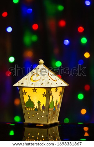Ramadan Kareem Eid al Adha Mubarak Arabic Vintage Traditional Retro Lantern Islamic Holy Festival Decoration Celebration Lamp on Reflective Glass with Colour-full Background Glittering Bokeh 