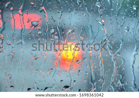 Heavy rain and rain drops on car windshield during rain, water droplets on glass window in rainy season.rain on car window.