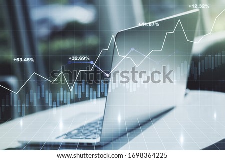 Double exposure of abstract creative financial chart on modern laptop background, research and strategy concept