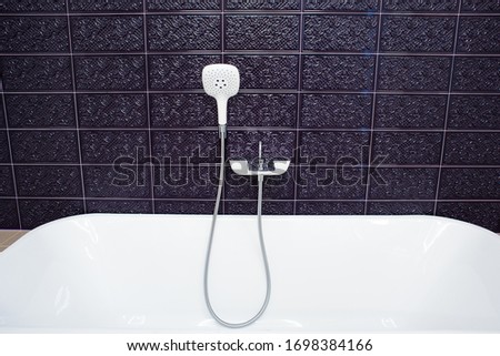 Concept of modern shower in tile background