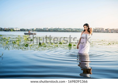 Making splashes in water by cute woman