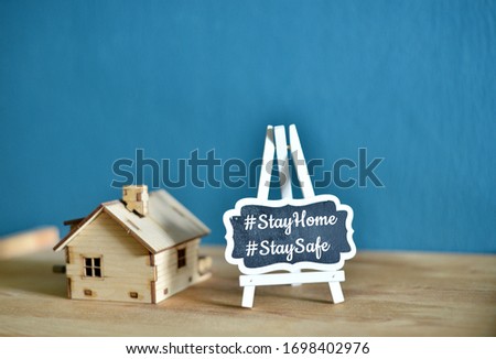 Social media awareness campaign and coronavirus prevention concept with word "STAYHOME STAYSAFE" isolated on darkblue background. Royalty-Free Stock Photo #1698402976