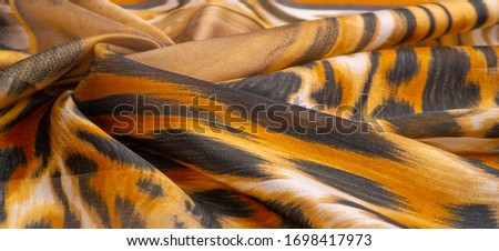 Texture, background, pattern, silk fabric, print on the theme of Africa, the skin of a wild beast