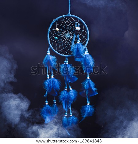 Dreamcatcher with smoke on a dark background