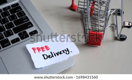 Free Delivery concept - Empty shopping cart or trolley with laptop. Shopping service on The online web. offers home delivery.