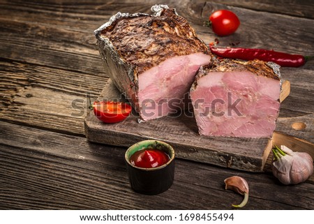 Traditional French Pate en croute with goose meat and liver as closeup on a wooden board.