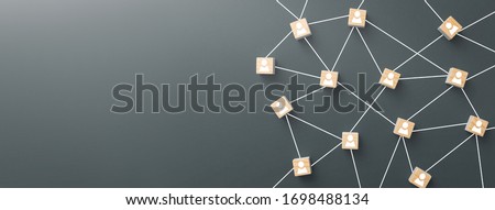 Wooden blocks connected together on blue background. Teamwork, network and community concept. Royalty-Free Stock Photo #1698488134