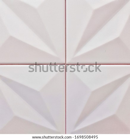 White ceramic tile with abstract pattern for wall and floor decoration. Concrete stone surface background. Convex texture for interior design project.