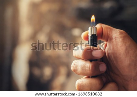 people man hand holding burning gas lighters arson conflagration damage background. Portable device used to create a flame. Safety and Set fire to insurance concept.  Royalty-Free Stock Photo #1698510082
