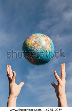 Hands catch the globe of the planet earth - care and support of mankind for the planet - ecology and nature protection