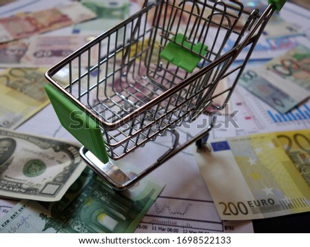 empty consumer basket against the background of financial charts and currencies