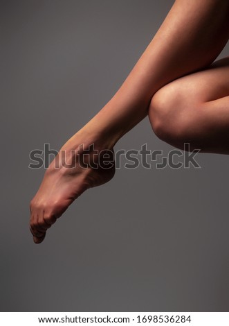 Ballerina's bare feet, ballet art on gray background