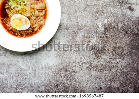 A picture part of one rare traditional food from Malaysia call "mee belacan" on crack floor. A noodle eat together with squid and shrimp paste soup.