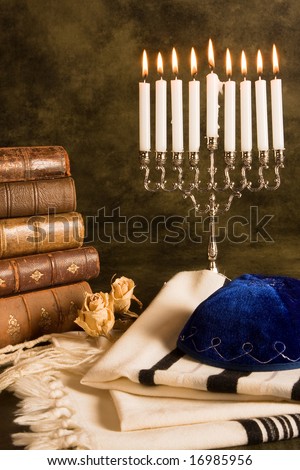 Hanukkah candleholder and jewish prayer shawl, books and cap