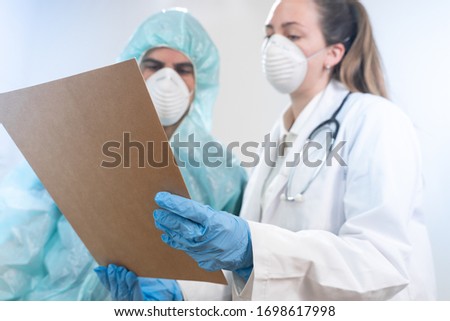 Coronavirus. Portrait of doctors and nurses working in the hospitals and fighting the coronavirus. Doctors are heroes. Doctors in the protective suits and masks looking for a cure for the disease. 