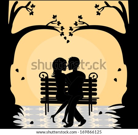 Lovers on the bench in the park under the trees at sunset