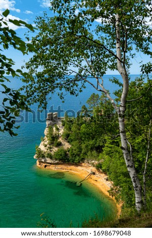 Miners Castle framed by a birch tree along Lake Superior.