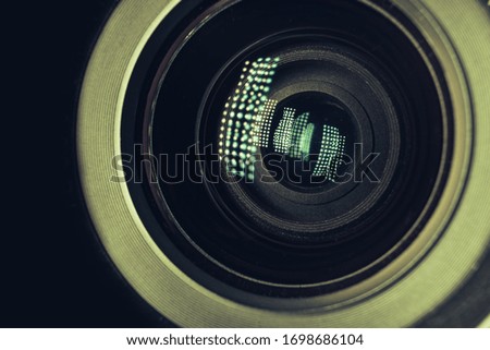 Beautiful camera lens with light reflection. Background pattern for design. Macro photography view.	