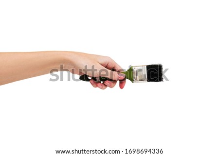 Paint brush in hand isolated on white. Paint concept.