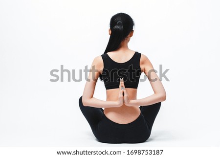 Sporty young woman doing yoga practice isolated on white background - concept of healthy life and natural balance between body and mental development
