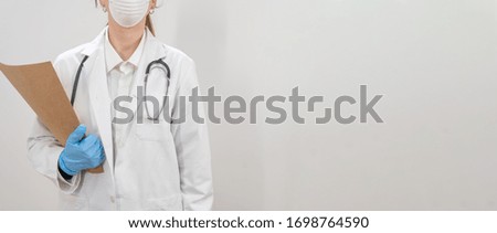 Coronavirus. Doctors and nurses working in the hospitals and fighting the coronavirus. Female doctor in the protective suit and mask looking for a cure for the disease. Copy text. 