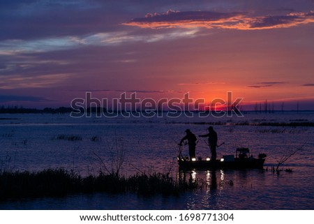 Bow fishing for carp on Lake Huron. Royalty-Free Stock Photo #1698771304