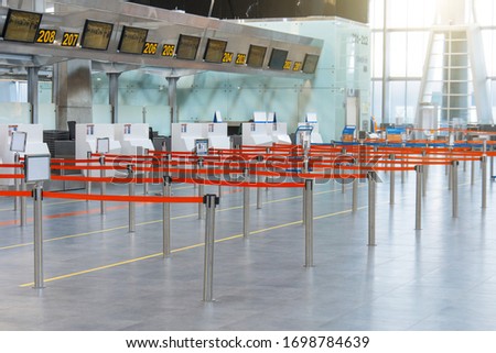 Empty paths bounded by a red ribbon to the check-in counters and baggage check-in at the passenger terminal