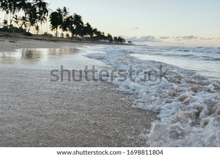 sandy beach with blue ocean with blue sky
