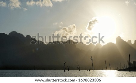 Beautiful scenery of sunshine with mountains background during summer time of Thailand,  Asia. 