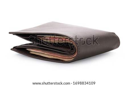 Side view of isolated genuine leather brown with many banknotes on white background. Cash concept and clipping path photo.