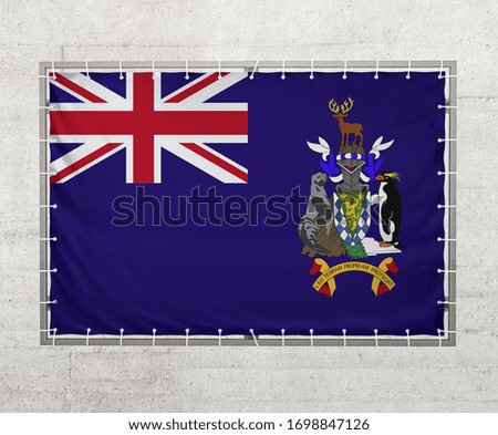 South Georgia and the South Sandwich Islands flag on a tarpaulin that is placed on a concrete wall
