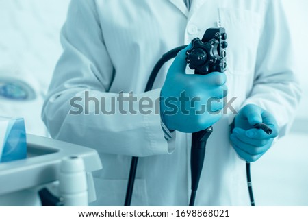 Close up of an endoscope in hands of a medical worker stock photo Royalty-Free Stock Photo #1698868021