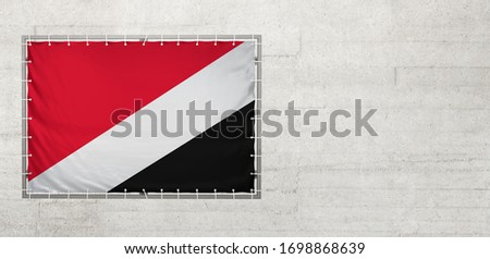 Sealand Principality of flag on a tarpaulin that is placed on a concrete wall