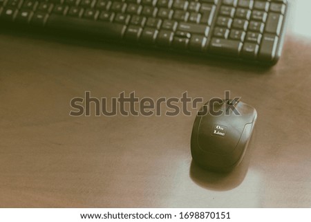 Black keyboard and computer mouse with word on line on wooden table. Working studding at distance at home concept.Toned image.Copy space