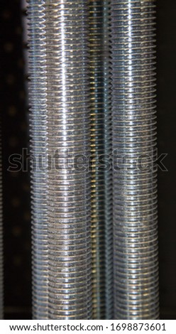View of threaded steel galvanized studs in beautiful thread structure, construction, metric fasteners, background, design.
