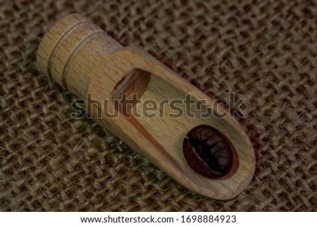 Coffee. Coffee beans macro photo. The texture of coffee beans. Coffee beans on a wooden spatula. Burlap texture