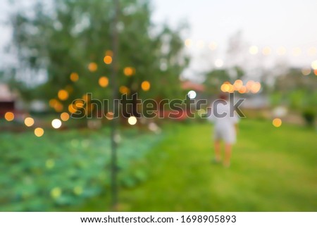 Blurred background of woman in garden.