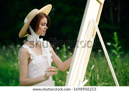 young woman with white canvas outdoors