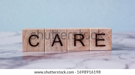 word care on a wooden block