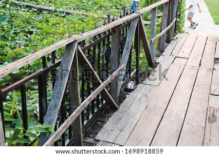 Vintage wooden foot bridge in garden.