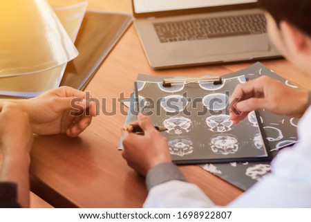 Blurred image,The doctor is diagnosing the tumor picture or cancer from the x-ray film of the patient's brain in order to plan treatment with tumor surgery or cancer from the patient's brain