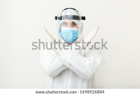 Doctor wearing protection suit, face mask show sign gesture stop pandemic epidemic of Covid-19, Coronavirus on white background. Concept of medicine health care covid coronavirus quarantine Stay home