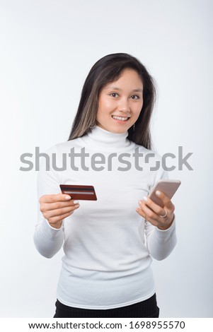 photo of young happy woman making online shopping with card and smartphone