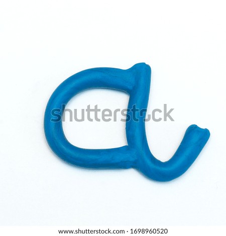 letter "A" from blue plasticine. Part of the word "mom." Preparation for the holiday. Mothers Day. Square format