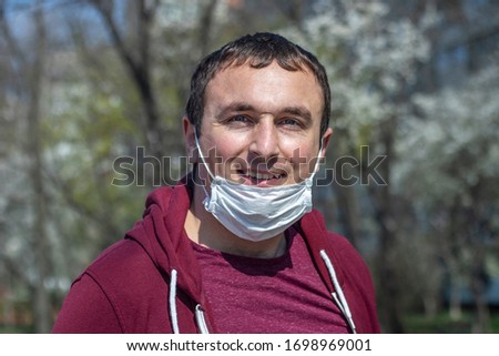 Portrait of man wearing surgical mask on chin. Masking policy concept. Royalty-Free Stock Photo #1698969001