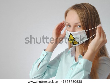 young woman in medical mask with virus sign print. health protection during the epidemic concept