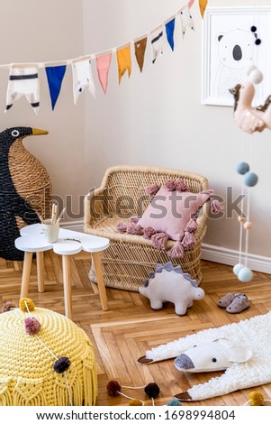 Stylish scandinavian interior of child room with natural toys, hanging decoration, design furniture, plush animals, teddy bears, mock up poster and accessories at modern home decor. 