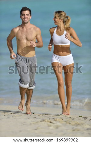 Couple jogging on a sandy beach